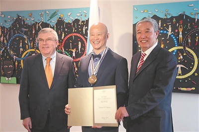 图为国际奥委会主席巴赫（左）向吕俊杰（中）颁奖。右为北京2022年冬奥会执行副主席于再清